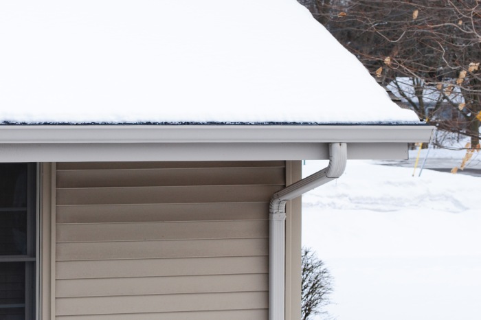 Raindrop Gutter Guard On A Neighbors House After Snowfall Without A Heat Cable